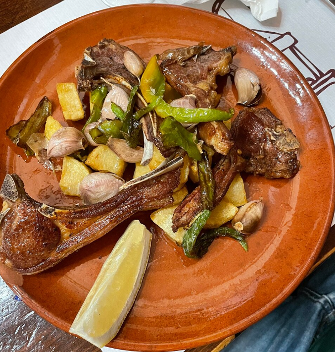 Un plato de comida con una rodaja de limón encima.