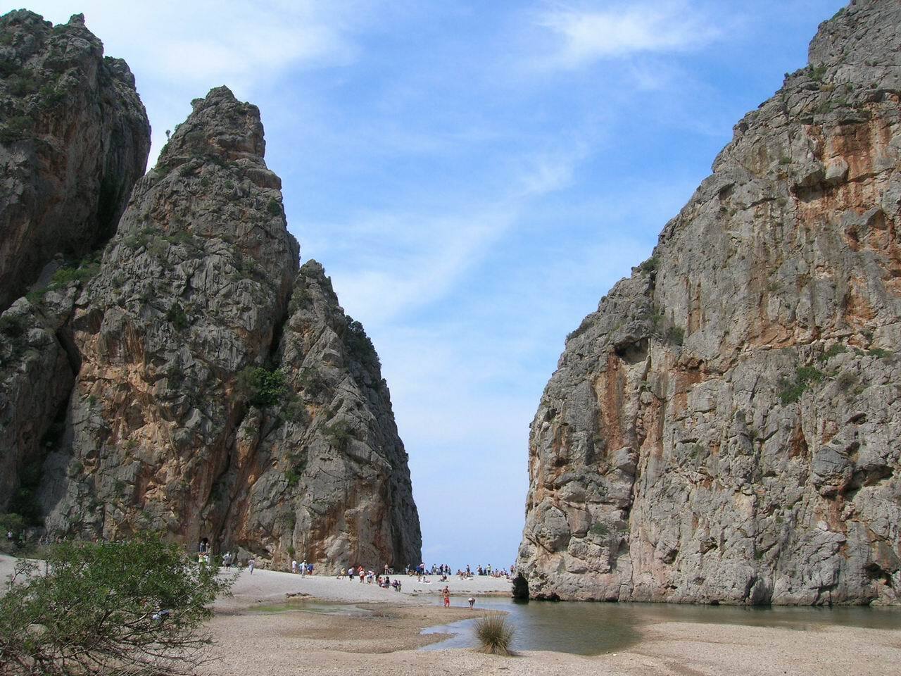 Stony riverbed between the vertical canyon walls